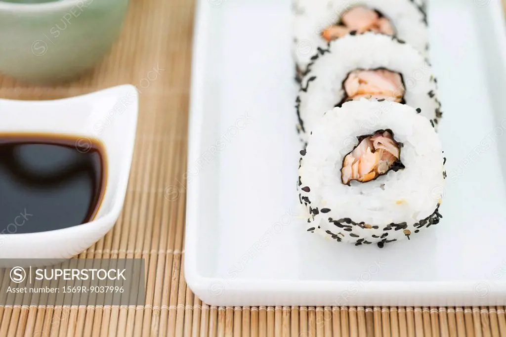 Cropped view of pieces of sushi with soy sauce, close-up