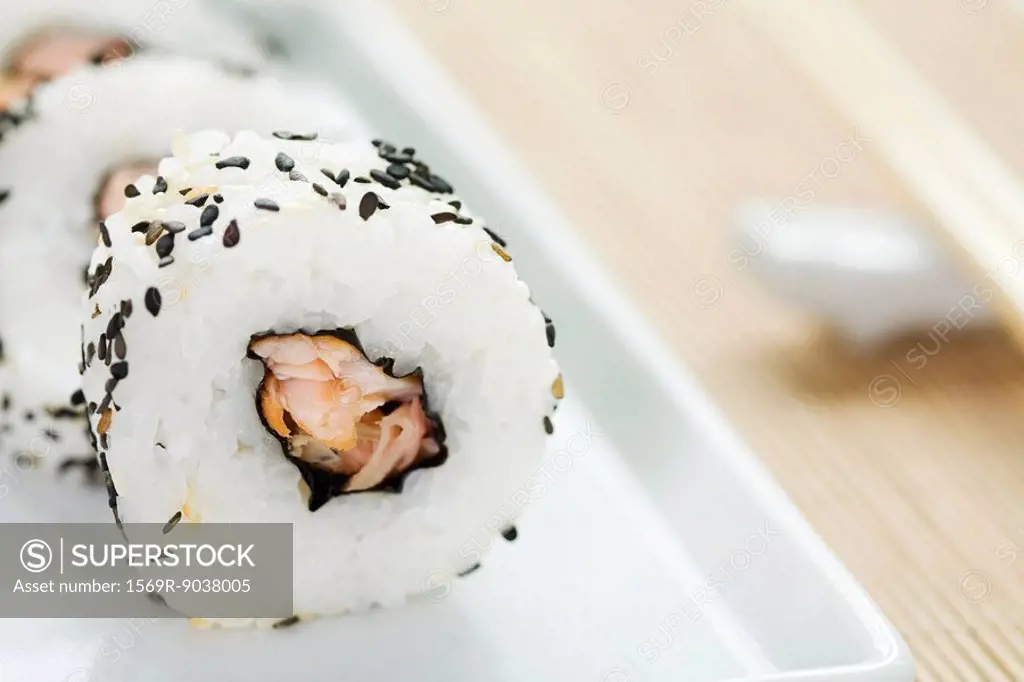 Maki sushi rolled in black sesame seeds, close-up