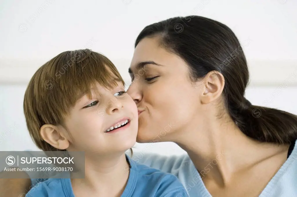 Mother kissing son on the cheek