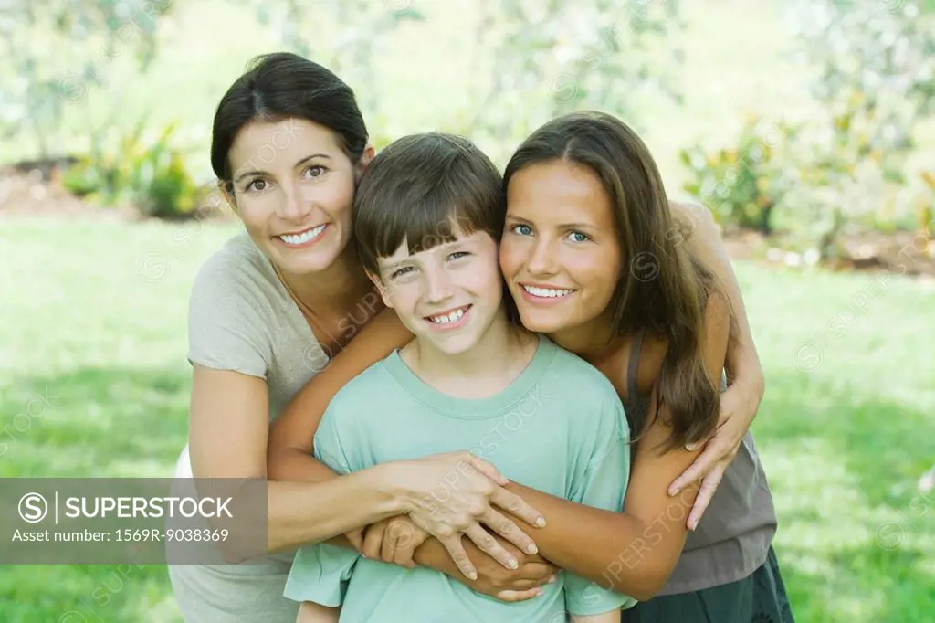 Mother with son and teen daughter, smiling at camera, portrait