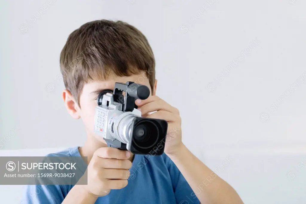 Boy using video camera