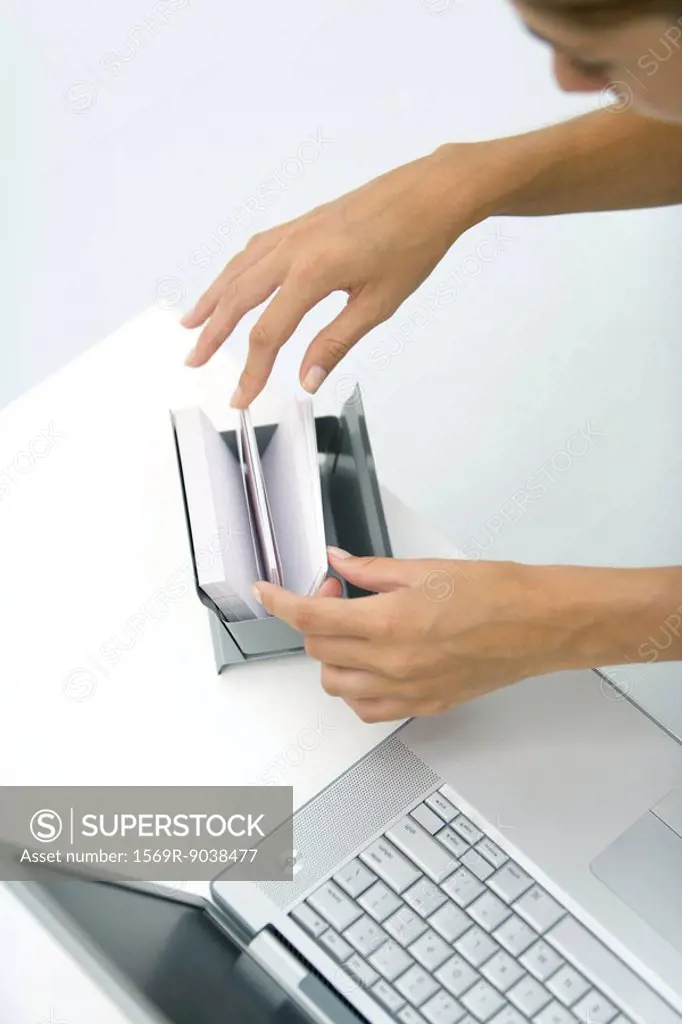 Woman flipping through card file, high angle view