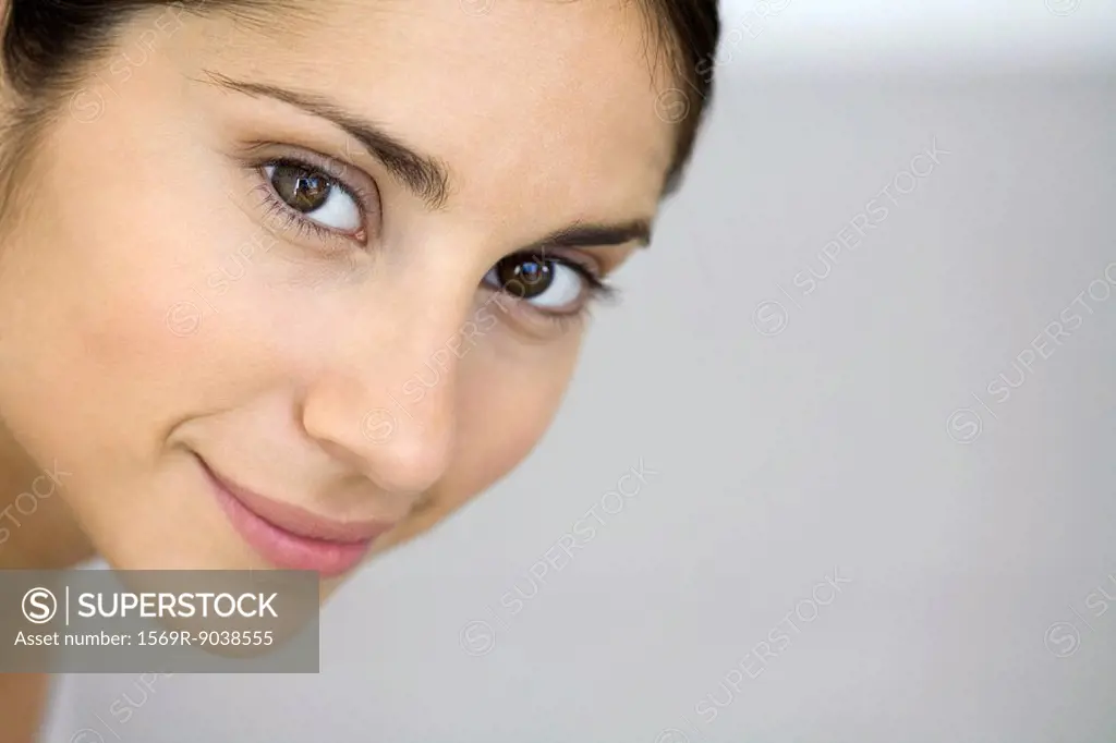 Woman smiling at camera, close-up, portrait
