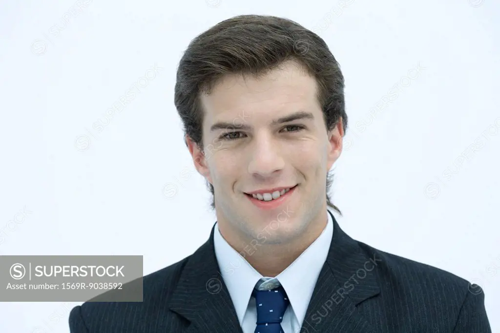 Young businessman smiling at camera, portrait