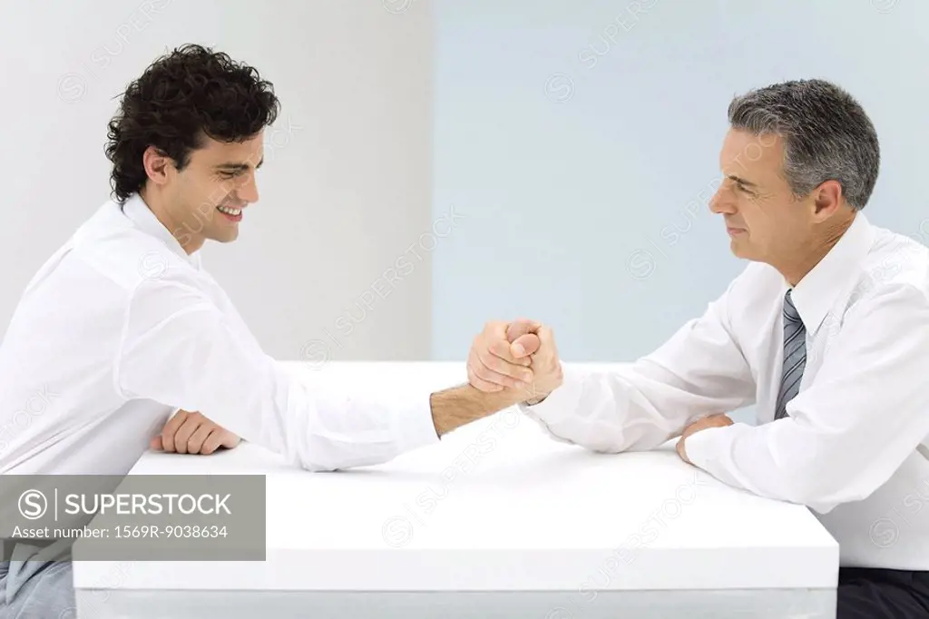 Two businessman arm wrestling