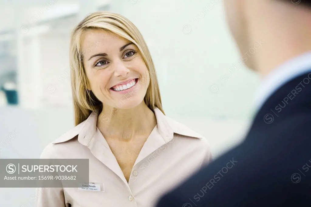 Professional woman smiling at man, cropped view