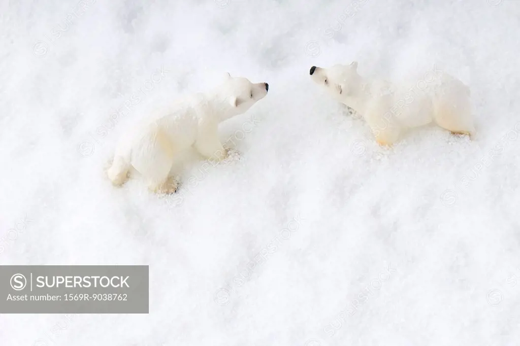 Toy polar bears in snow, overhead view