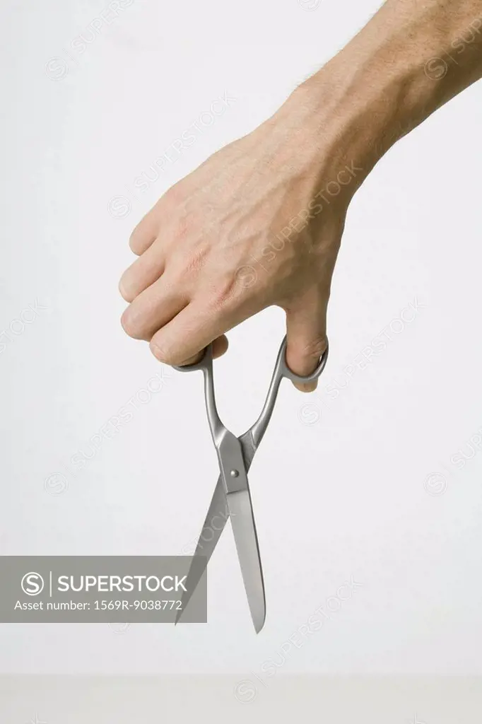 Hand holding scissors, close-up