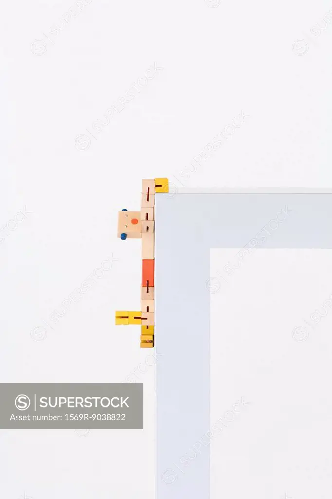 Wooden toy hanging on to edge of table