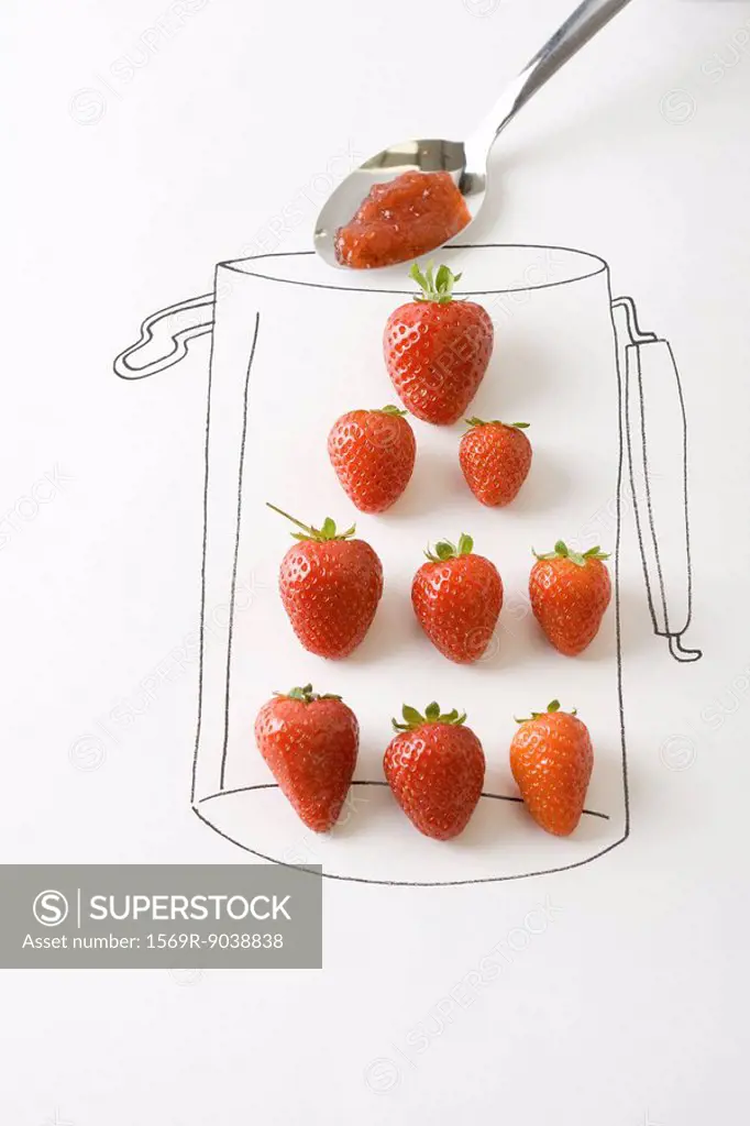 Spoonful of strawberry jam over jar of fresh strawberries