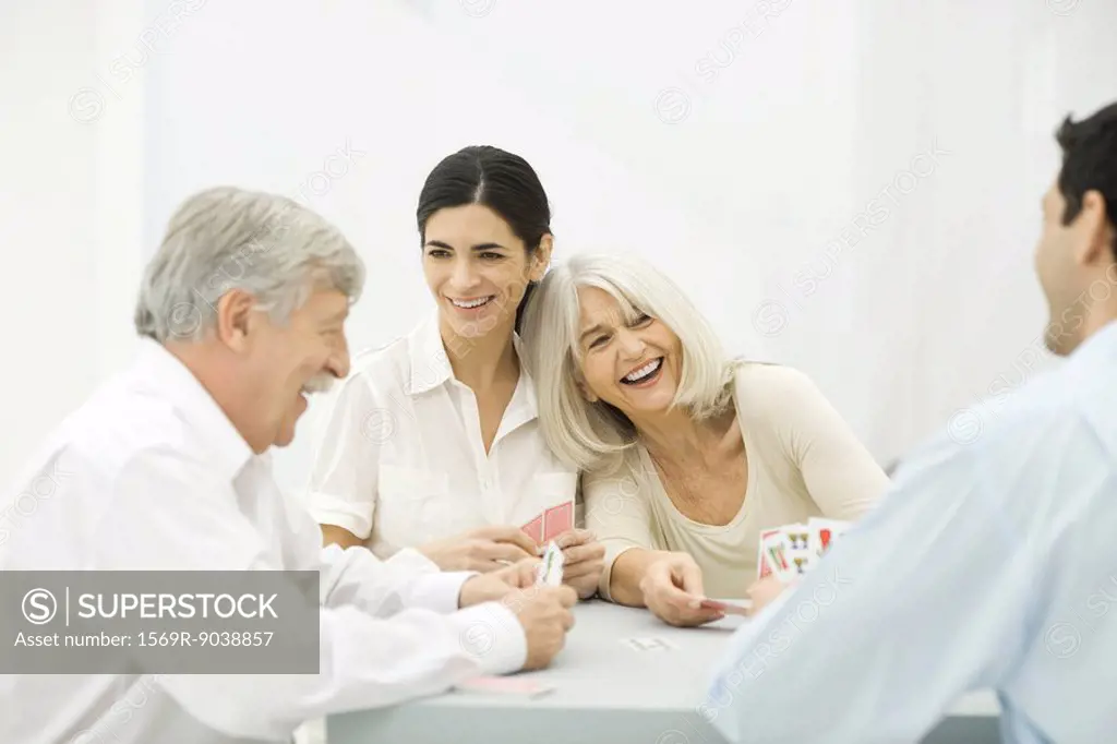 Family playing cards, laughing