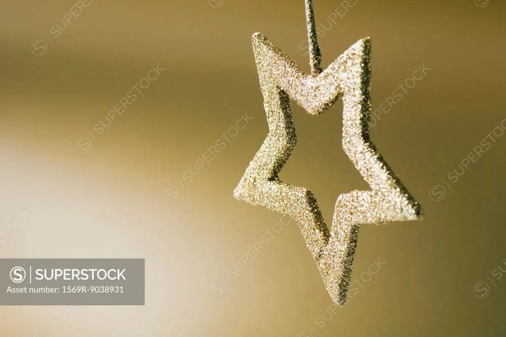 Golden star shaped Christmas tree ornament, upside down