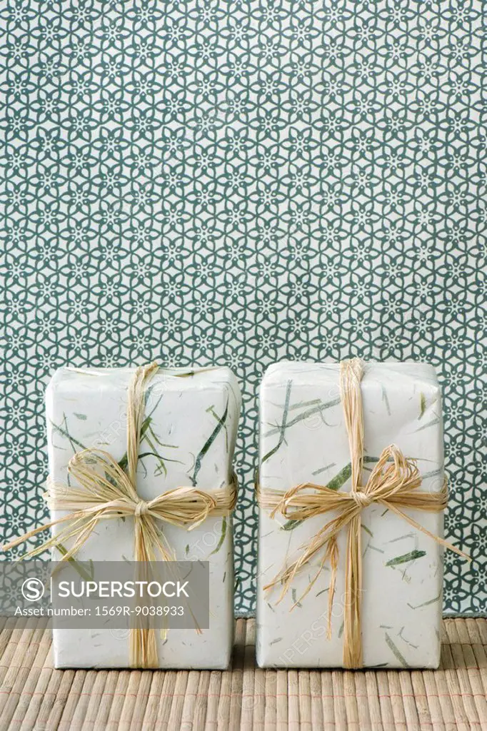 Two gift wrapped presents side by side, standing on end