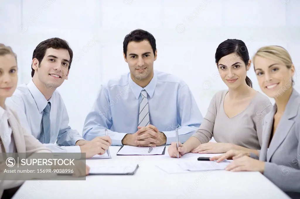 Businessman sitting with colleagues at conference table