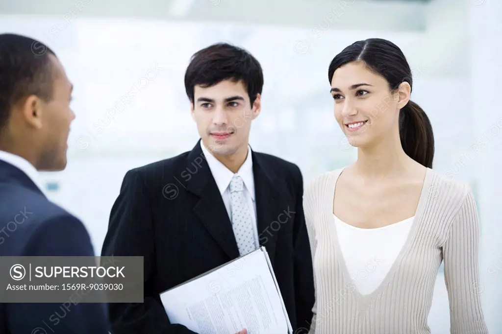 Professional woman chatting with male colleagues