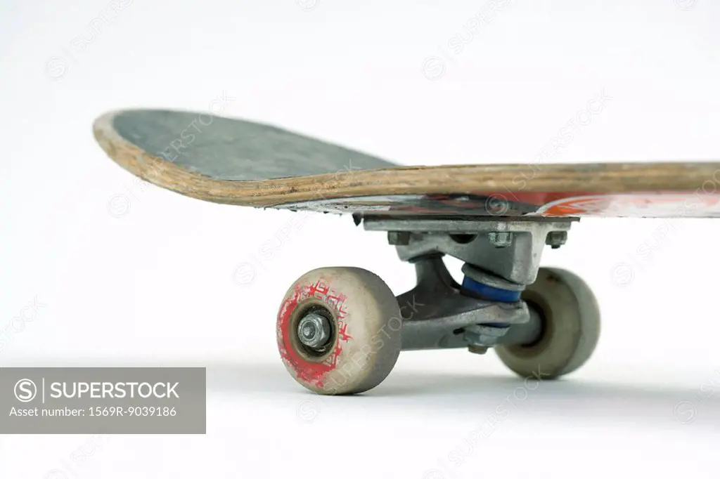 Close-up of frequently ridden skateboard, cropped