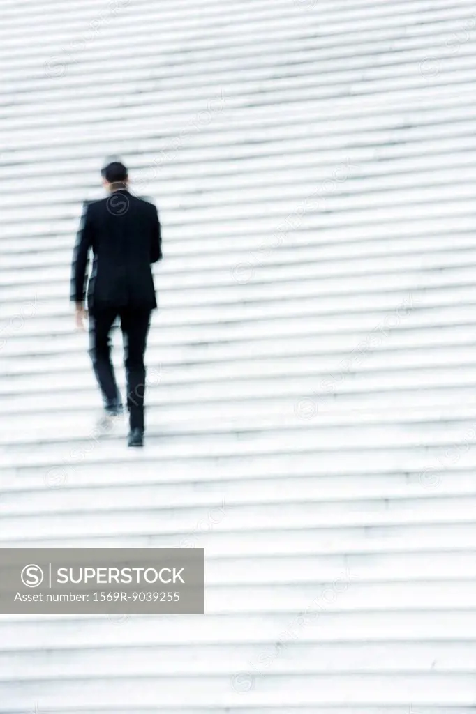 Businessman ascending stairs outdoors
