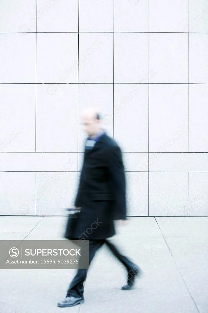 Businessman walking on sidewalk