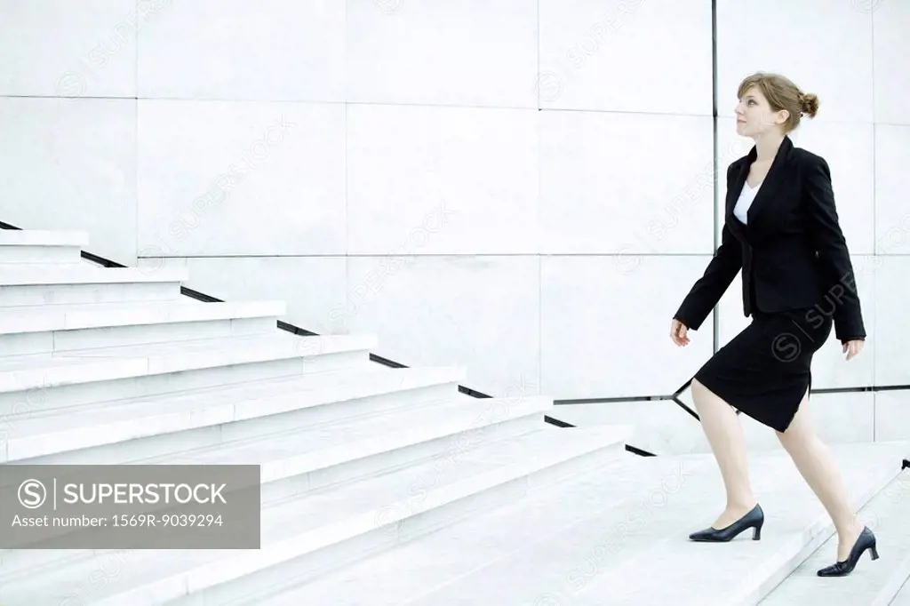 Businesswoman ascending steps