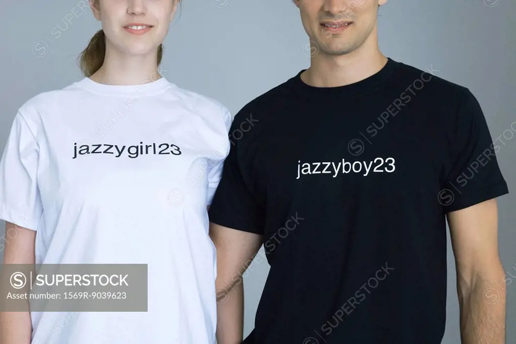 Couple wearing customized tee-shirts, smiling, cropped view