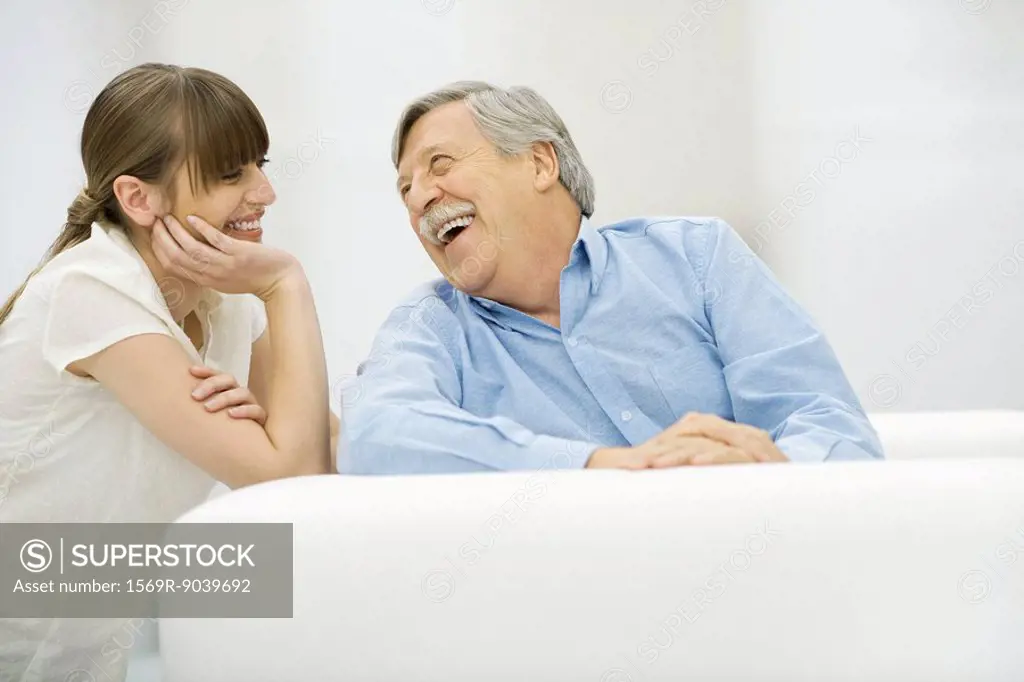 Senior man and adult daughter laughing together