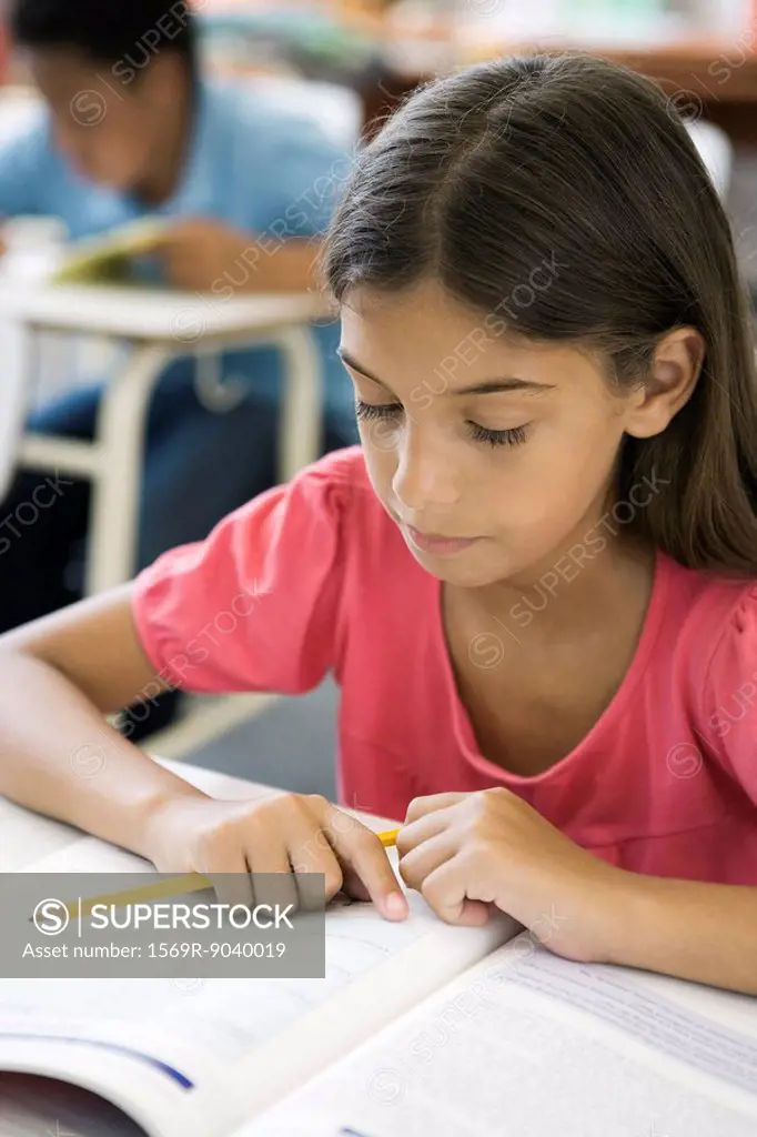 Female elementary school student doing classwork
