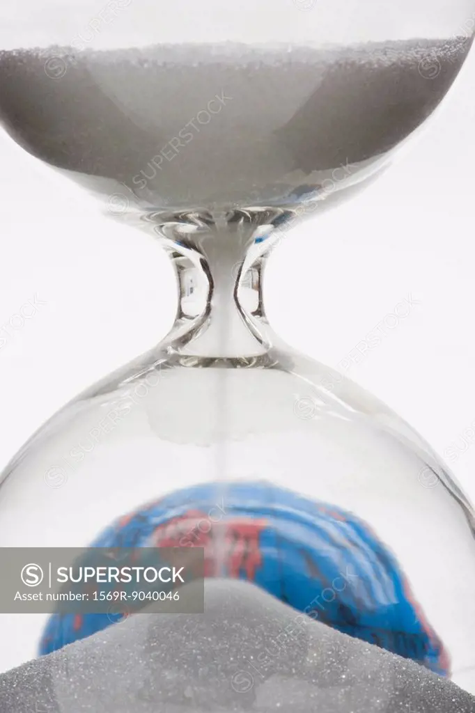 Hourglass, globe in background