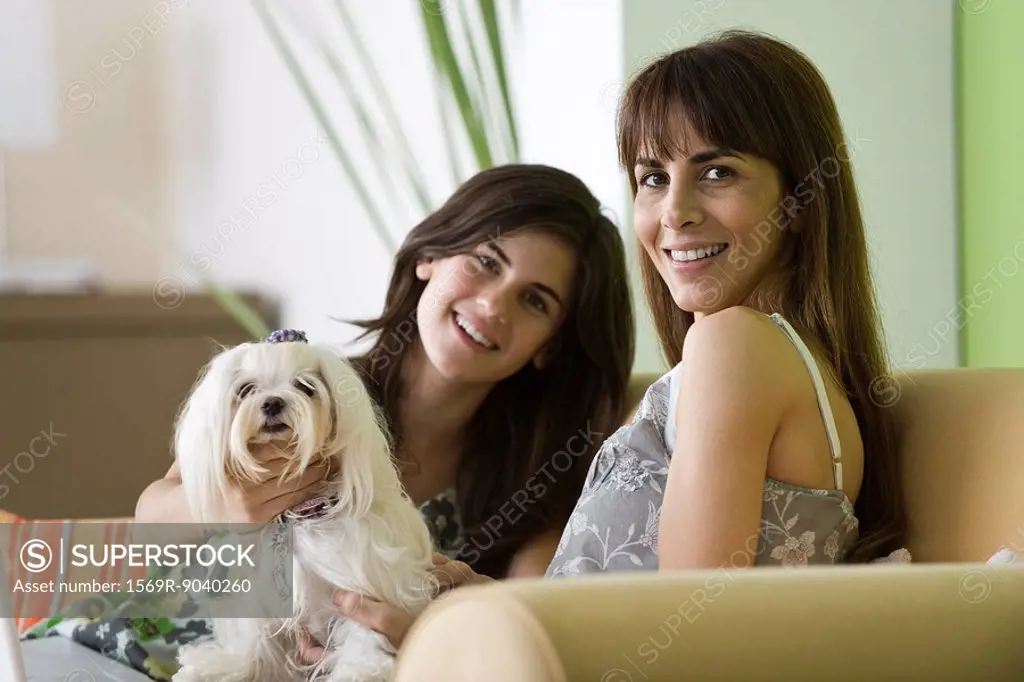 Mother and teenage daughter with pet dog, portrait