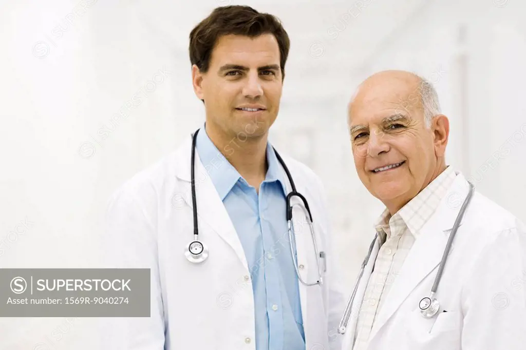 Doctors together in hospital corridor, portrait