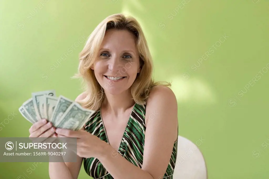 Woman holding handful of cash