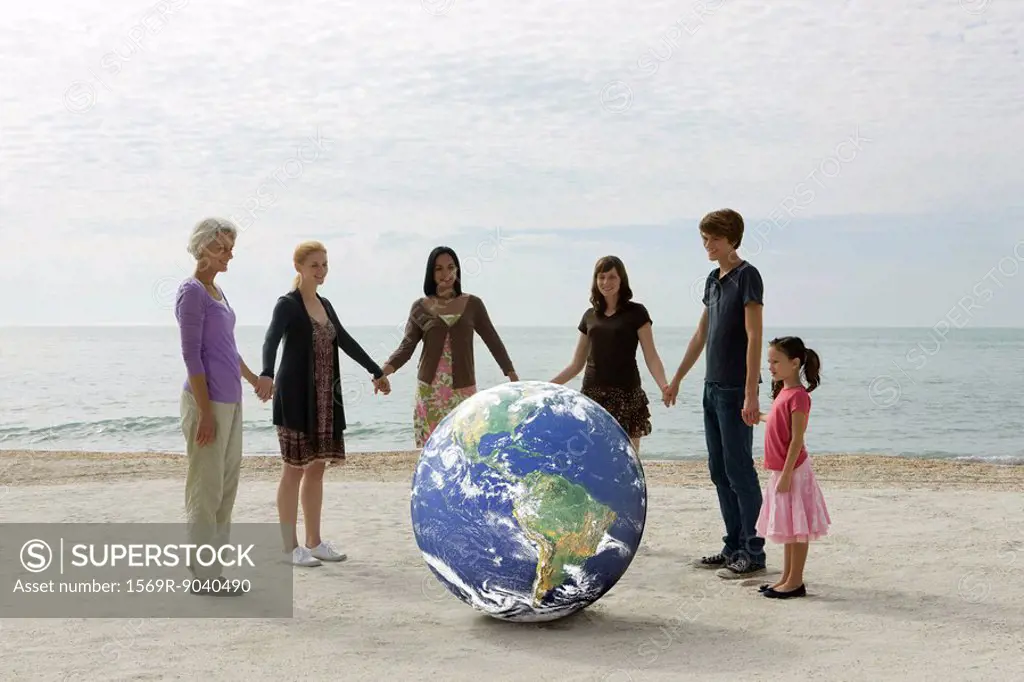 Ecology concept, group of people holding hands, standing around the planet earth