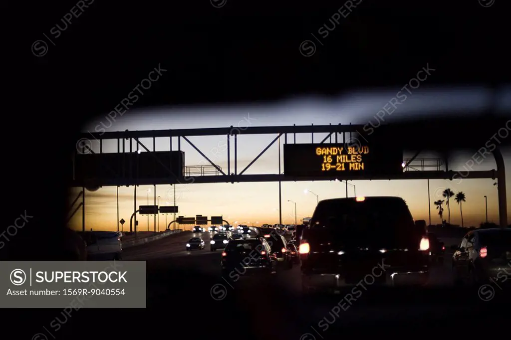 Driving in traffic at sunset