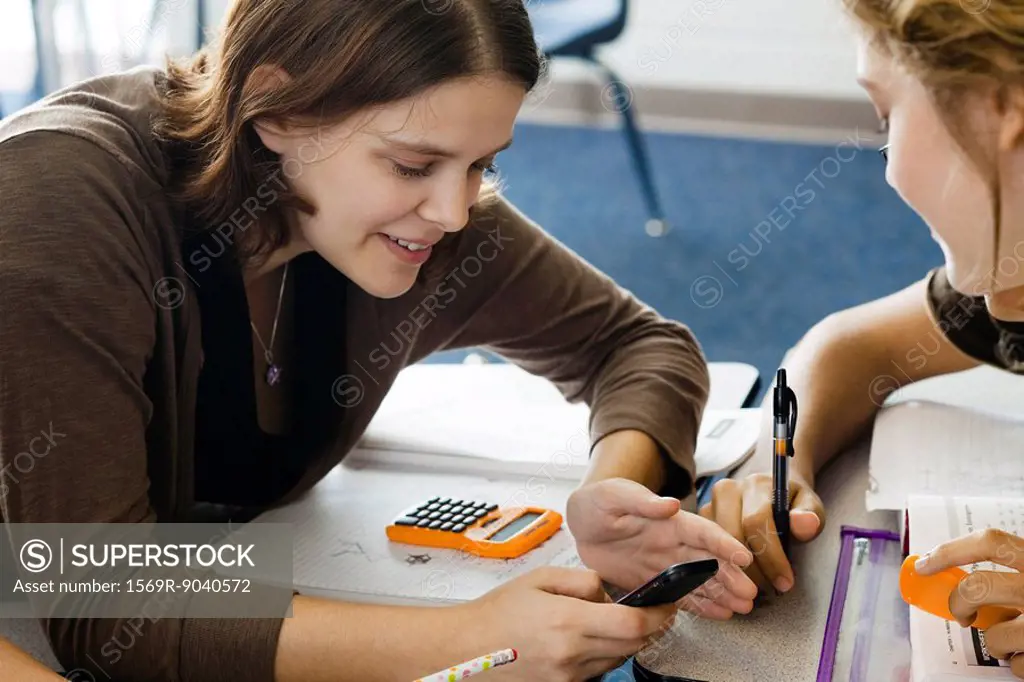 Students looking at cell phone in class