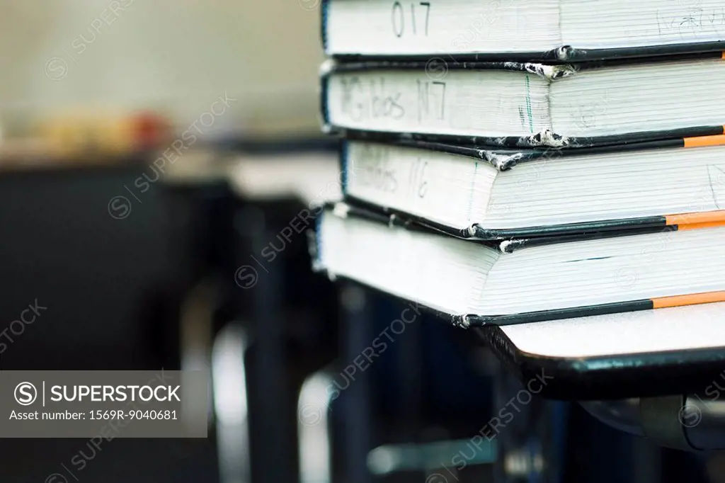 Stack of textbooks on school desk