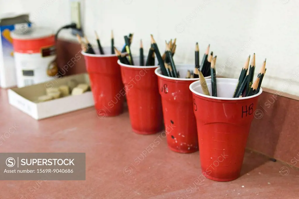 Artists drawing pencils organized in cups