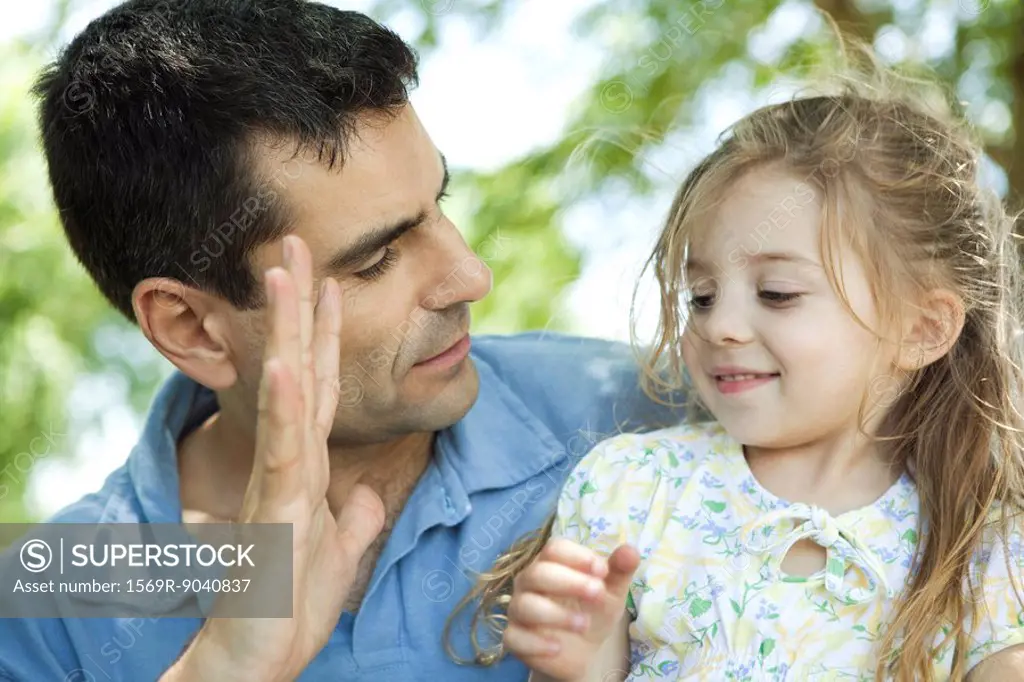 Father showing daughter his hand