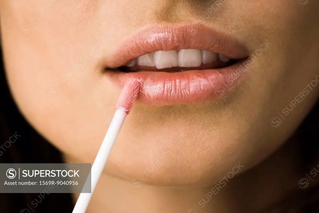Applying lip_gloss with lip brush