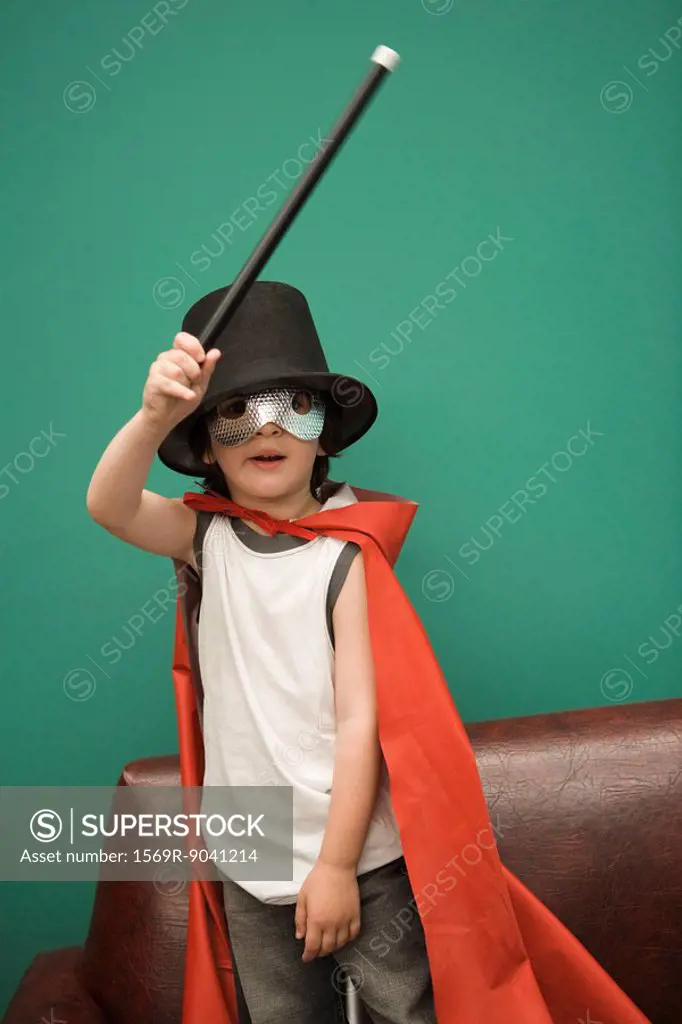 Boy in costume pretending to be magician