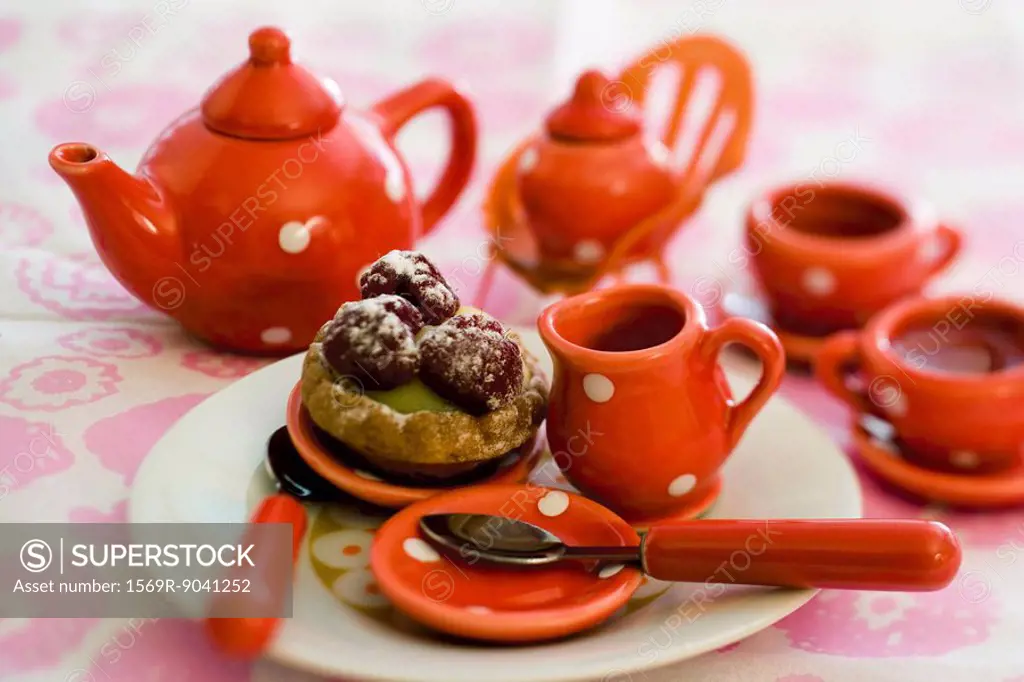 Toy tea set with pastry
