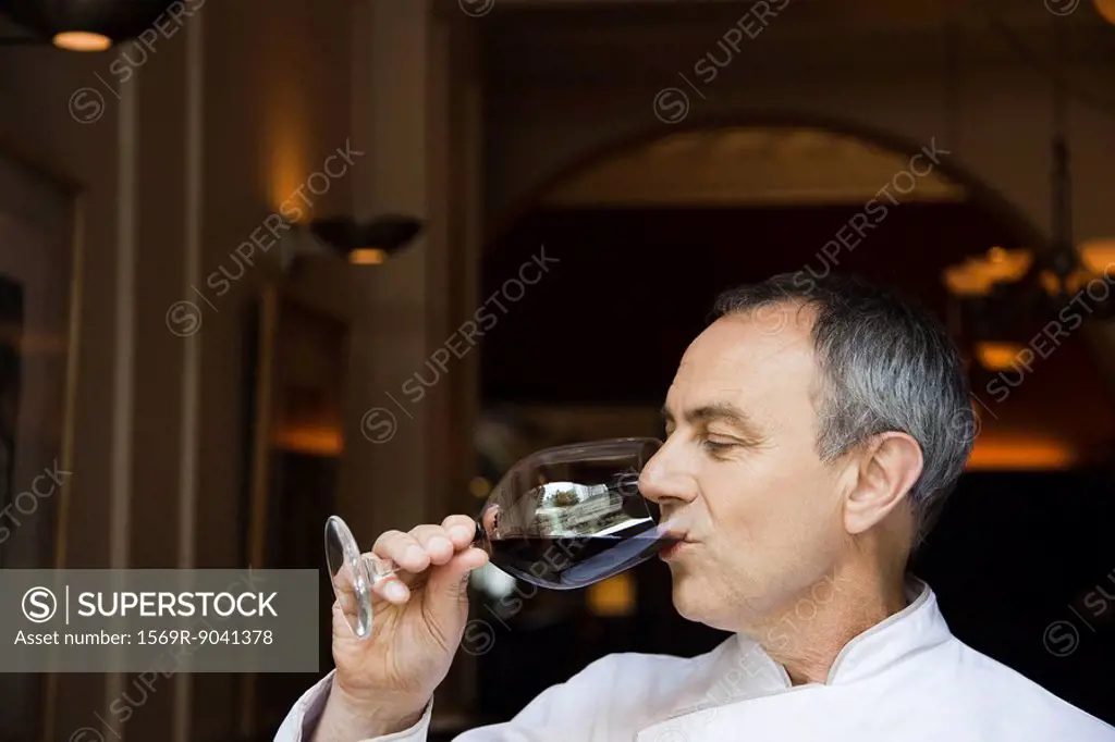Mature man drinking red wine