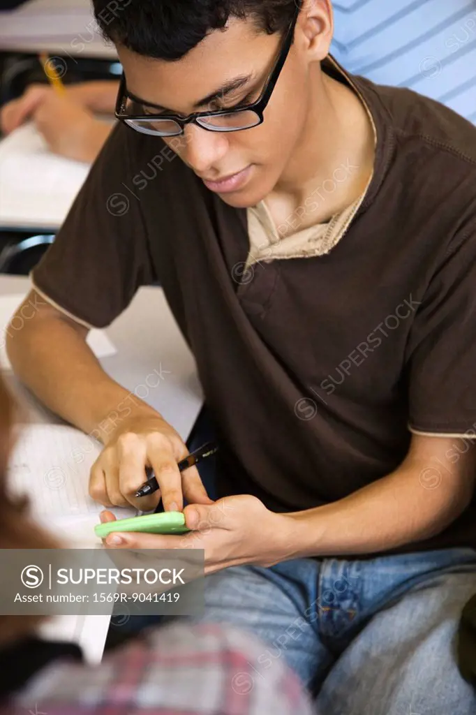 High school student using calculator in class
