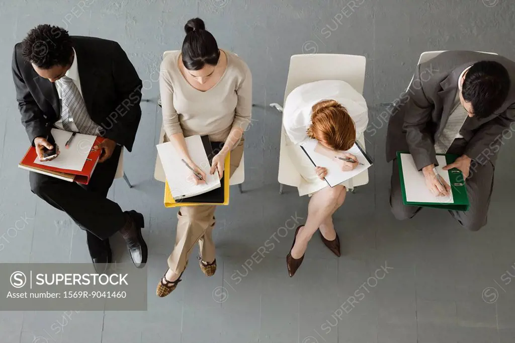 Professionals taking notes during meeting
