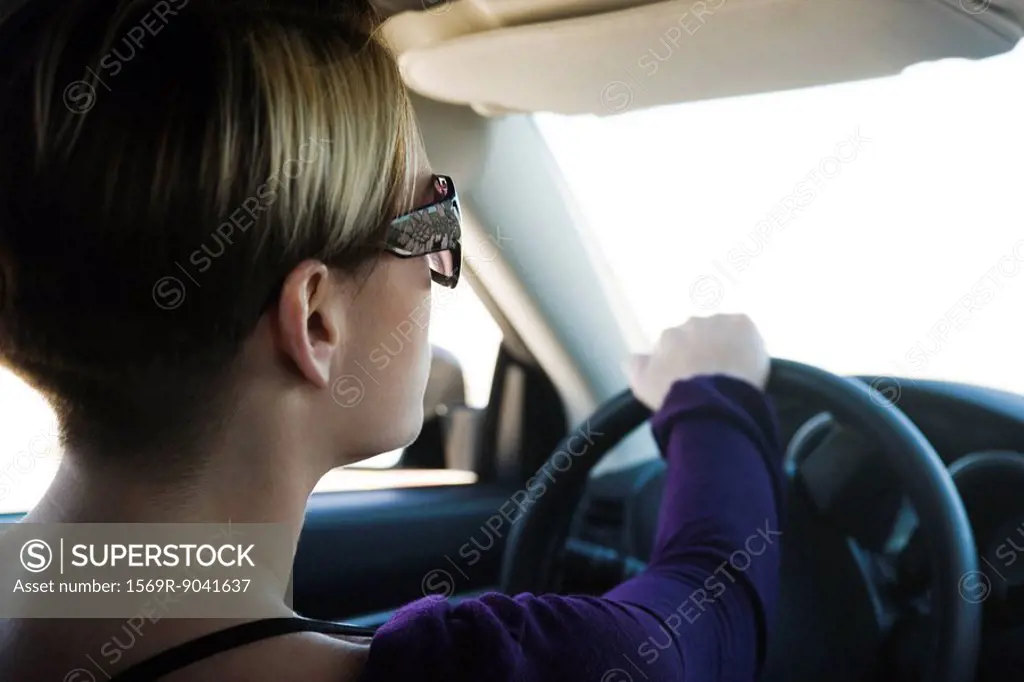Woman driving, concentrating on road ahead
