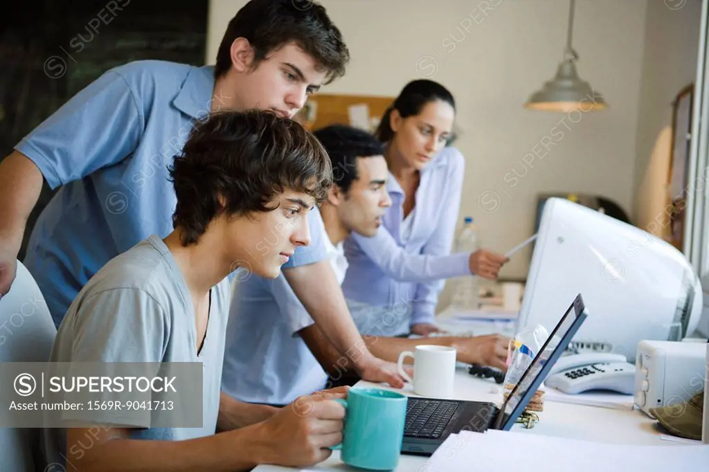 College students collaborating together using computers