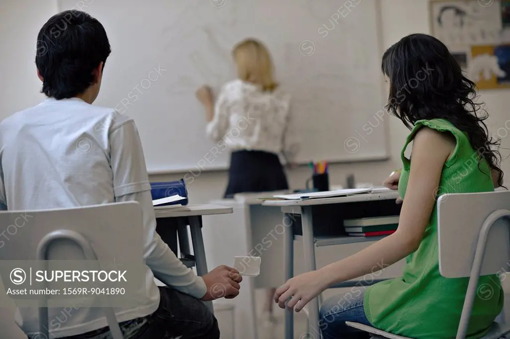 High school students passing notes in class