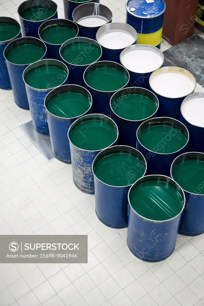 Fabric coating plant, metal drums containing a liquid plasticizer used for coating textiles