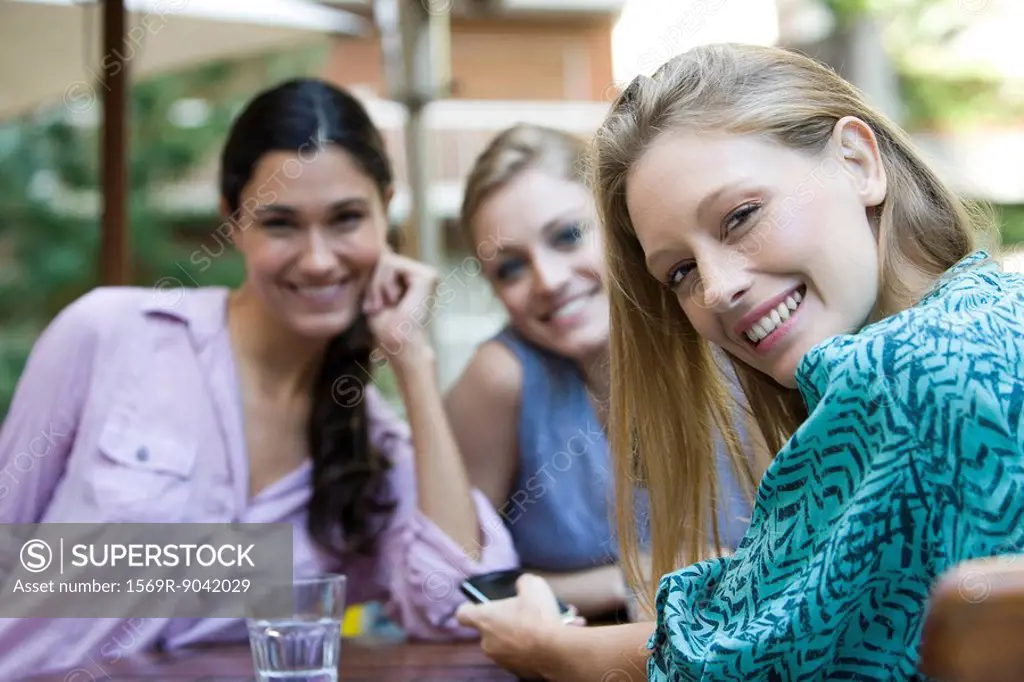 Young woman with friends at cafe