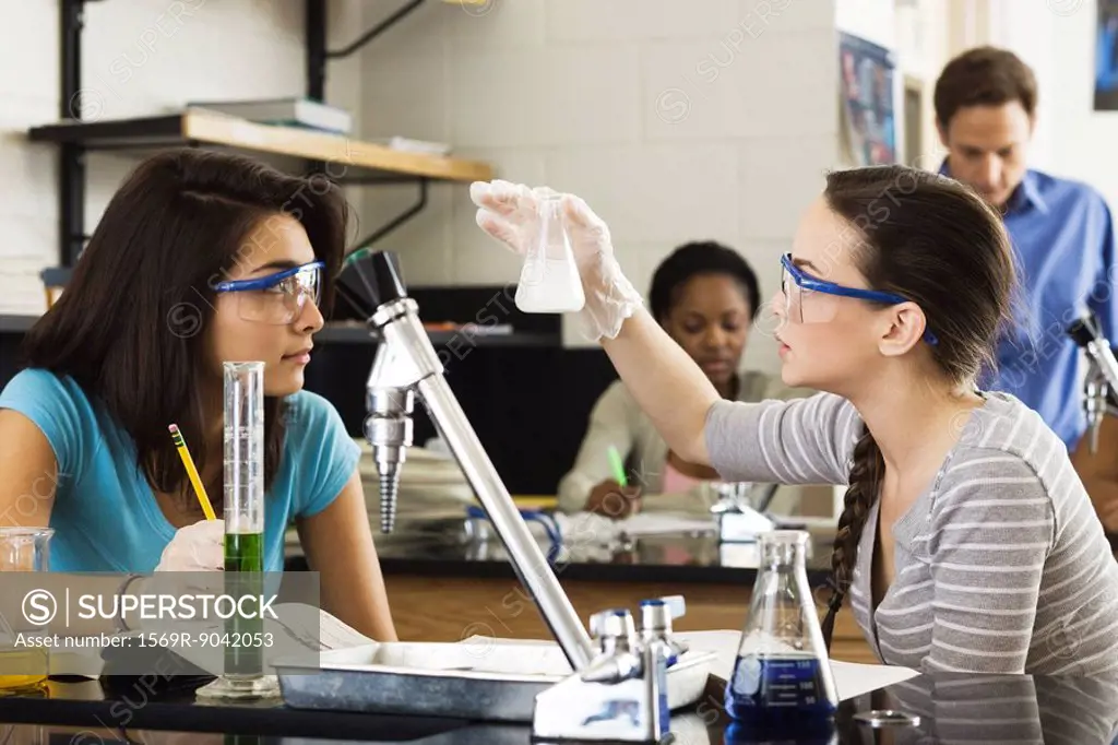High school students conducting experiment in chemistry class
