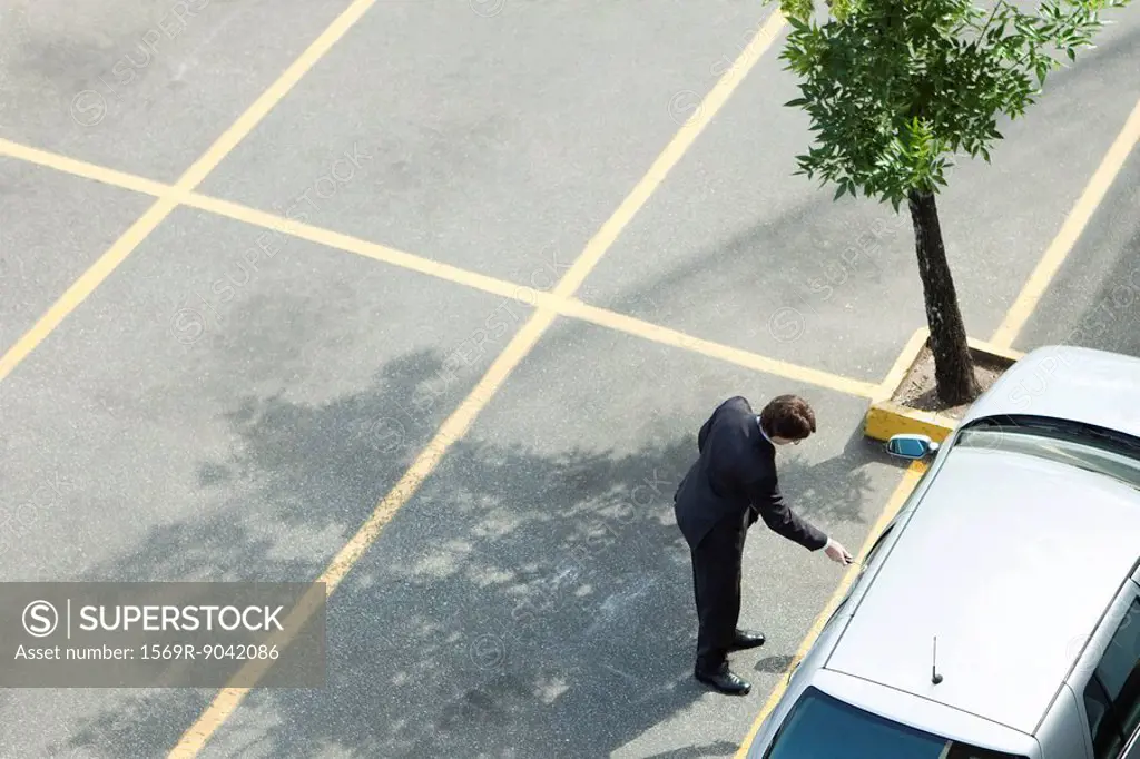 Businessman unlocking car door