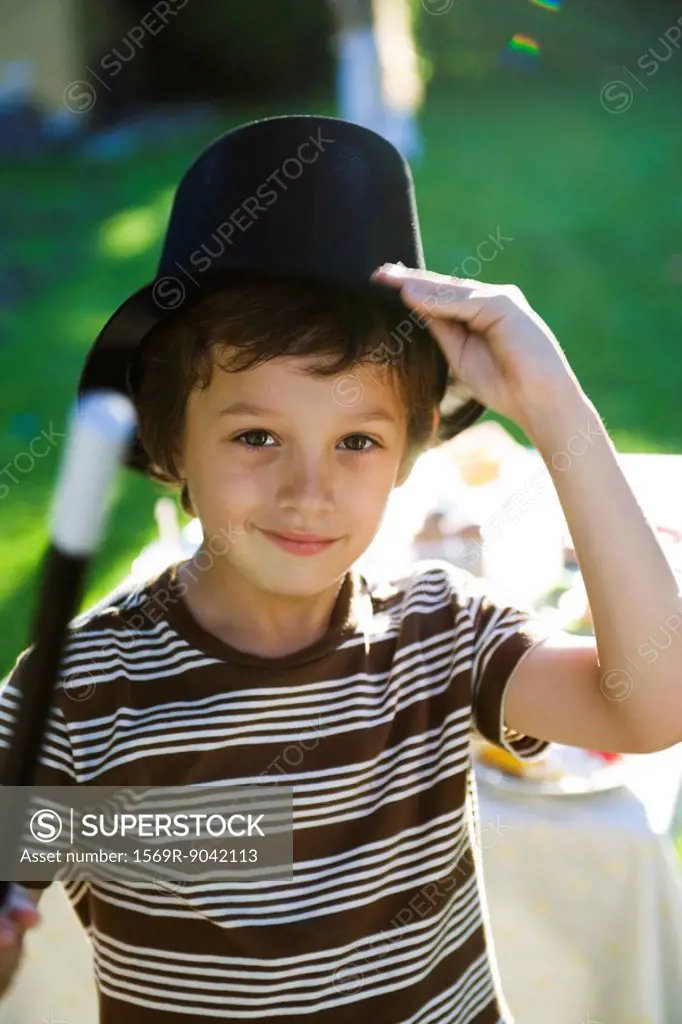 Boy with magic wand and magician´s hat, portrait